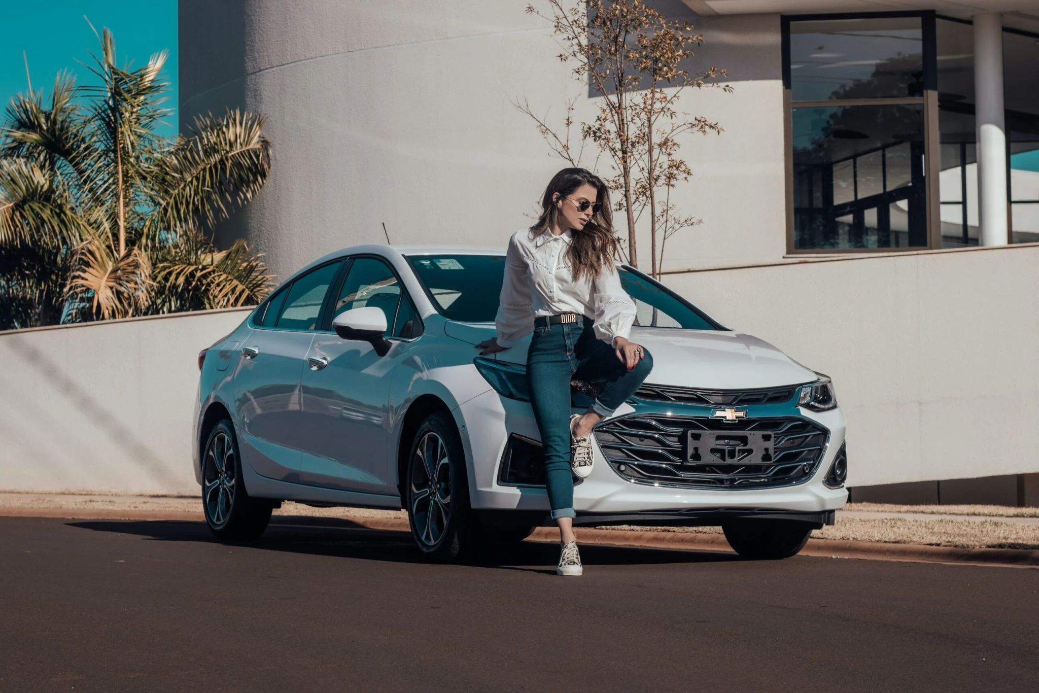 raphael-lovaski-GIGXTbZ_VPY-unsplash-scaled-2048x1366 woman sitting on the hood of a white sedan